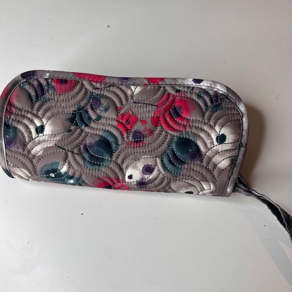 Lug clutch wallet features a distinctive quilted pattern and floral print design